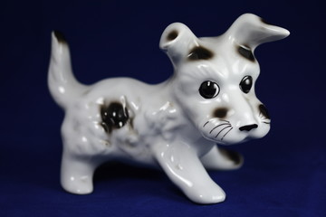  puppy, Ceramic figurine, isolated on blue   blackground