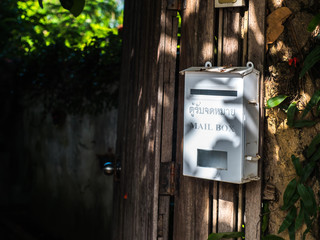 White mail box in front of old house