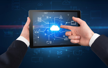 First person view of a hand using tablet with cloud office concept
