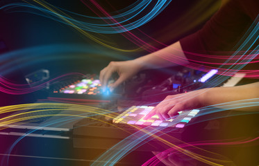 Fototapeta na wymiar Hand mixing music on midi controller with colorful vibe concept 