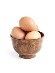 organic eggs in wooden bowl