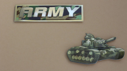 army sign next to a tank laying flat on a tan background with writing space