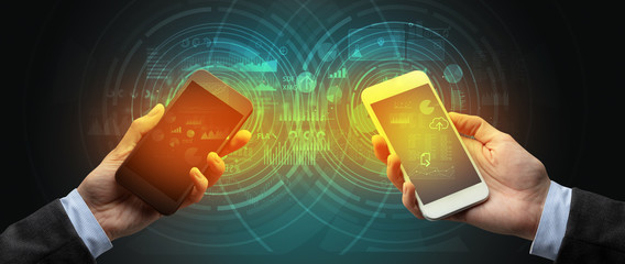 Close up of two smartphones syncing business data