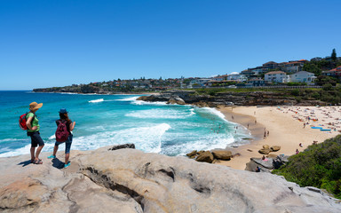 Fototapeta premium Unrecognizable people enjoying the view of Tamarama beach during coastal walk from Tamarama point in Sydney Australia