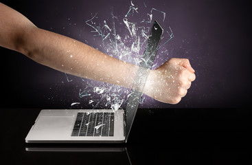 Obraz na płótnie Canvas Hand hitting strongly laptop screen glass 