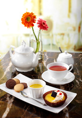 Delicious English afternoon tea set on a white background