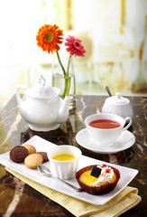 Delicious English afternoon tea set on a white background