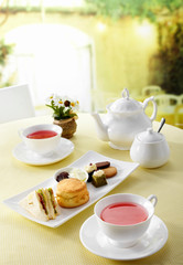 Delicious English afternoon tea set on a white background