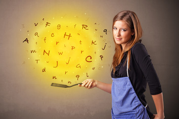 Obraz premium Young person cooking letters in wok 
