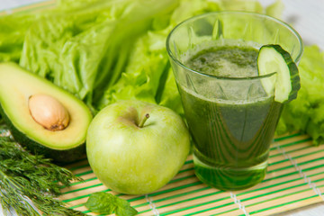 Naklejka na ściany i meble Healthy green smoothie with ingredients on wooden background