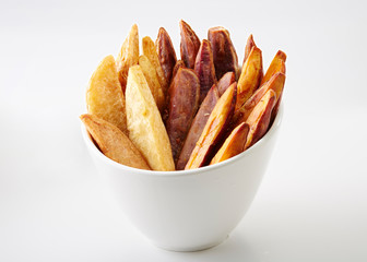 Delicious bicolor fries on white background