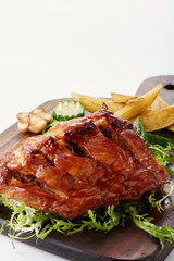 Delicious grilled pork chops on a white background