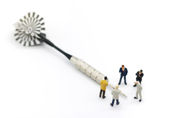 Miniature people: Business team standing with dart. Business efficiency goals concept.