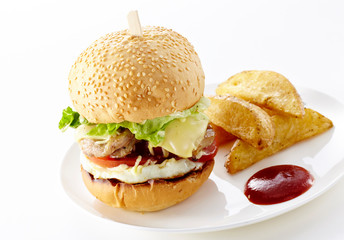Tasty burger with french fries on a white background
