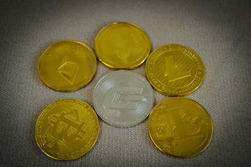 Golden coin of virutal currency laying on  bark background