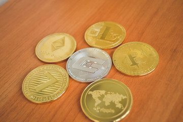 Golden coin of virutal currency laying on  bark background