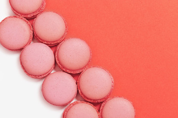 Sweet macaroons in row. Bright macaroon biscuits close up on paper background with copy space. Trend color 