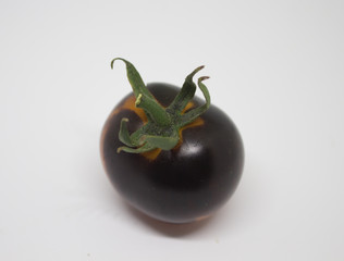 Black tomato on white background