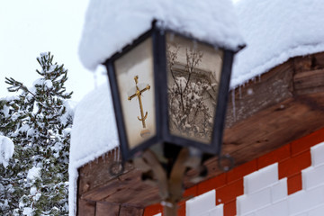 Street lamp in the snow reflects the surrounding buildings,texture,background..