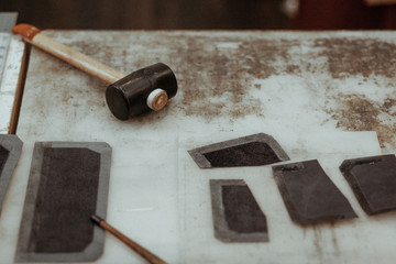 Leather craftmans work desk . Pieces of leather and working tools on a work table. Leather craft.