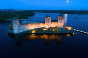 View of the ancient  Olavinlinna fortress on a July night (shooting from a quadrocopter). Savonlinna, Finland