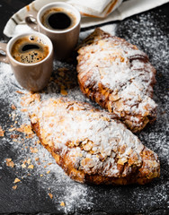 Croissants with almonds on the black background