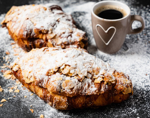 Croissants with almonds on the black background