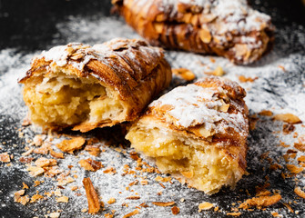 Croissants with almonds on the black background
