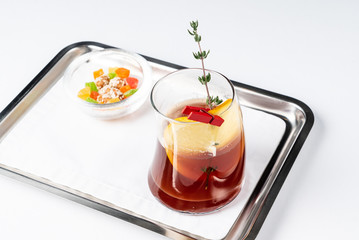 fruit tea with orange and candied fruits on the silver tray, isolated
