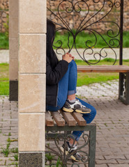 Girl sitting on a park bench