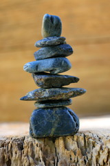 Black spa stones set up on old wood.