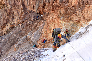 group climbers climbs to the rock slope of mountain, Fann, Pamir Alay, Tajikistan