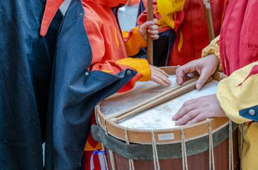 A drummer with drum holding a sticks laying on the drum