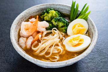 Sour soup with shrimp, egg and vegetables