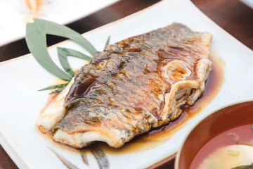 fish slice fried with teriyaki sauce serve on japanese plate