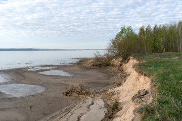  On the bank of a wide river in the early morning in spring