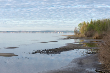  On the bank of a wide river in the early morning in spring