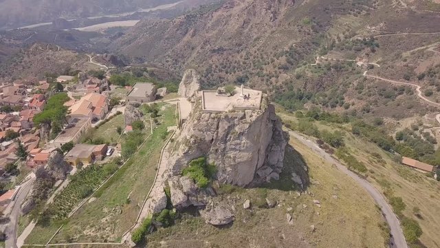 Stunning orbit 4k drone aerial footage around the rock and Catholic cross in Bova, a small Italian village in the hills in Calabria