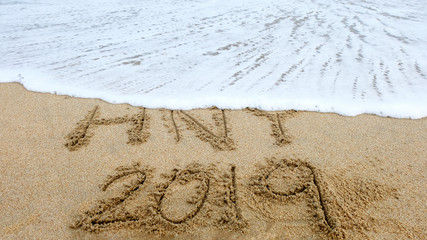 New year,2019 write on sand beach and ocean view, 2019 on the beach.