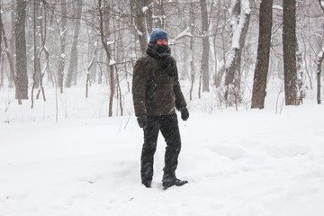 Fototapeta na wymiar Alone man in the snow forest 