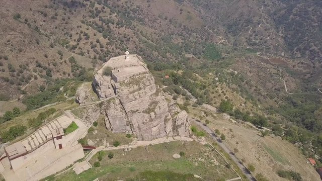 Stunning orbit 4k drone aerial footage around the rock and Catholic cross in Bova, a small Italian village in the hills in Calabria