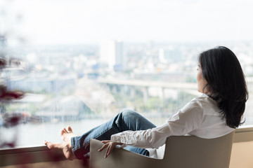 Simple healthy living lifestyle menopause aged Asian woman take a rest relaxing with self...