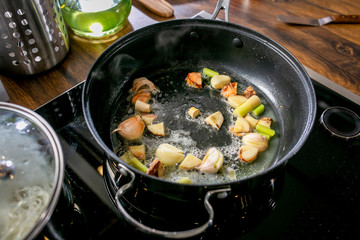 Chef fry garlic in a pan. Master class in the kitchen. The process of cooking. Step by step. Tutorial. Close-up