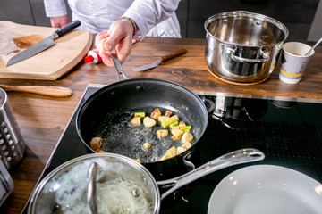 Chef fry garlic in a pan. Master class in the kitchen. The process of cooking. Step by step. Tutorial. Close-up