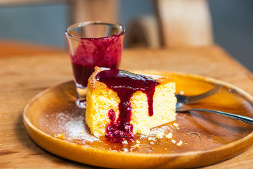 Bread and strawberry jam on a wooden table suitable for hot coffee. Warm morning