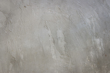 Rugged surface of old grey plastered wall