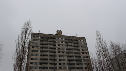 An abandoned building overgrown with trees in Pripyat, the Chernobyl zone, the consequences of a...