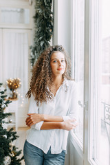 Portrait of a young girl with a smile and cupcakes. Photo shoot in the interior light Studio.