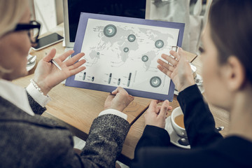 Stylish elegant women working in corporation having negotiation