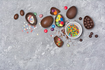 Chocolate traditional easter eggs with bright colorful dragee and sugar sprinkles in bowl